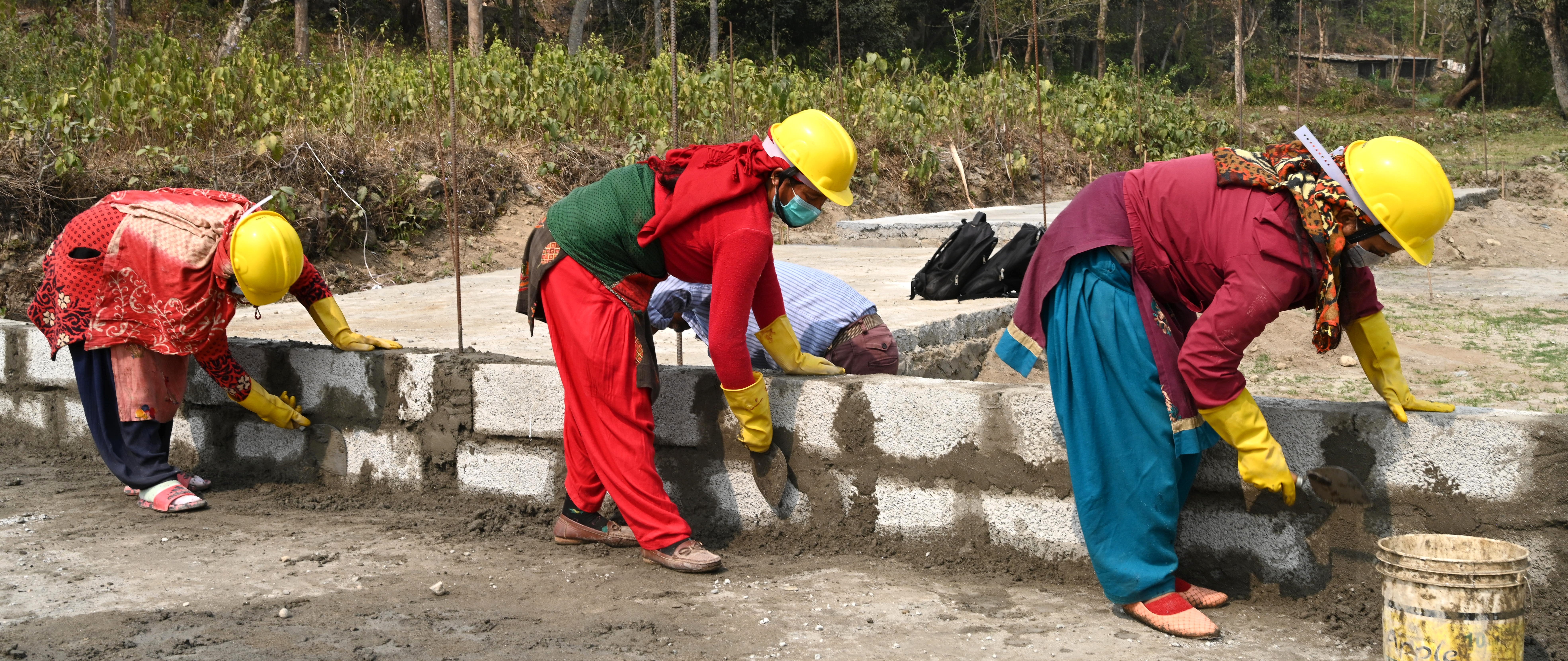 Three women masons reconstructing house of a vulnerable beneficiary in Bidur, Nuwakot